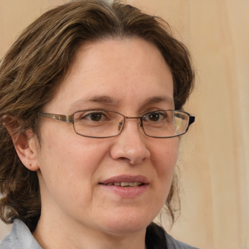 Joyful white adult female with medium  brown hair and blue eyes