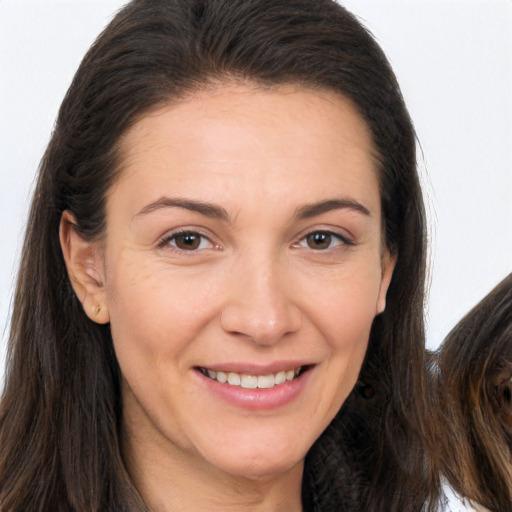 Joyful white adult female with long  brown hair and brown eyes