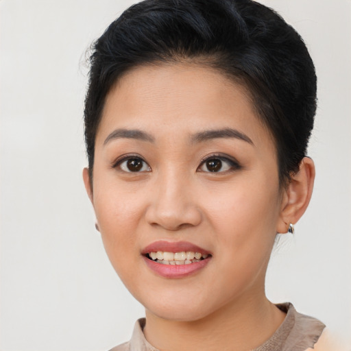 Joyful asian young-adult female with short  brown hair and brown eyes