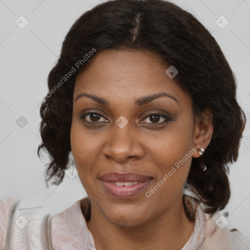 Joyful black adult female with medium  brown hair and brown eyes