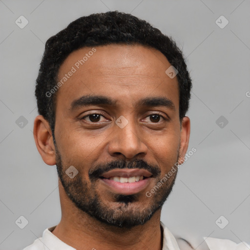 Joyful black young-adult male with short  black hair and brown eyes