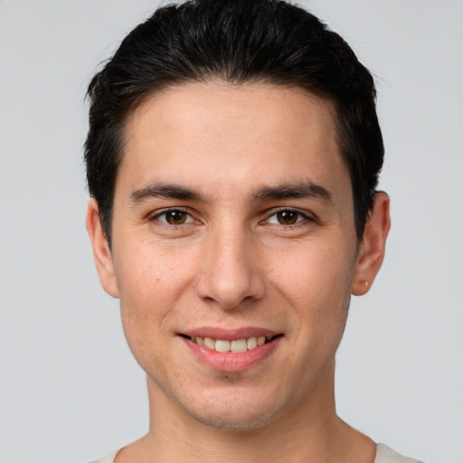 Joyful white young-adult male with short  black hair and brown eyes