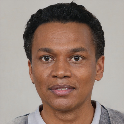 Neutral black adult male with short  black hair and brown eyes