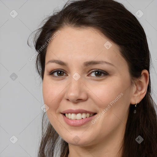 Joyful white young-adult female with long  brown hair and brown eyes