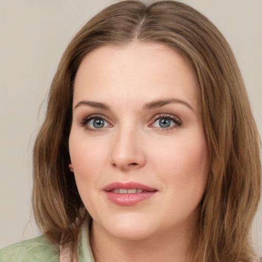 Joyful white young-adult female with medium  brown hair and green eyes