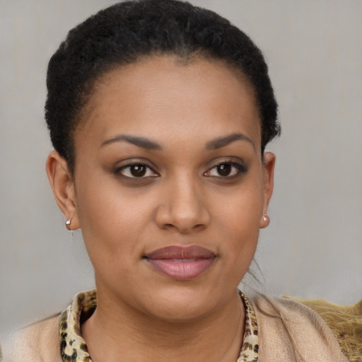 Joyful black young-adult female with short  brown hair and brown eyes