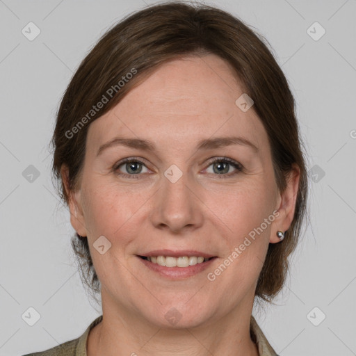 Joyful white adult female with medium  brown hair and grey eyes