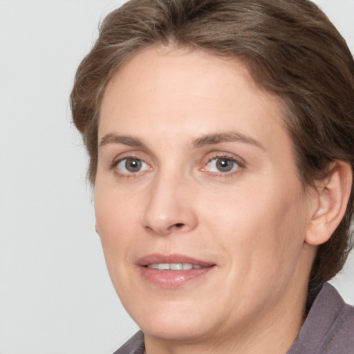 Joyful white adult female with medium  brown hair and grey eyes