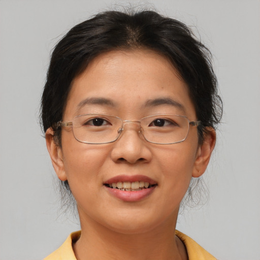 Joyful asian adult female with short  brown hair and brown eyes