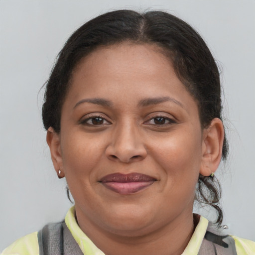 Joyful latino adult female with short  brown hair and brown eyes