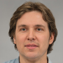 Joyful white adult male with medium  brown hair and brown eyes