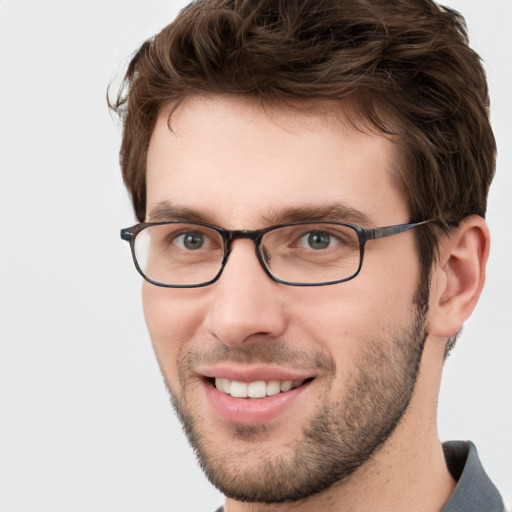 Joyful white young-adult male with short  brown hair and green eyes