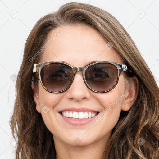 Joyful white young-adult female with long  brown hair and blue eyes