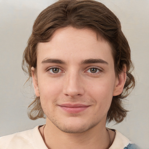 Joyful white young-adult male with medium  brown hair and brown eyes