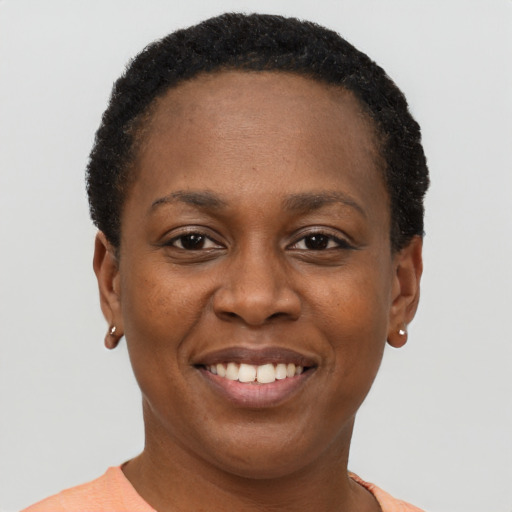 Joyful black young-adult female with short  brown hair and brown eyes