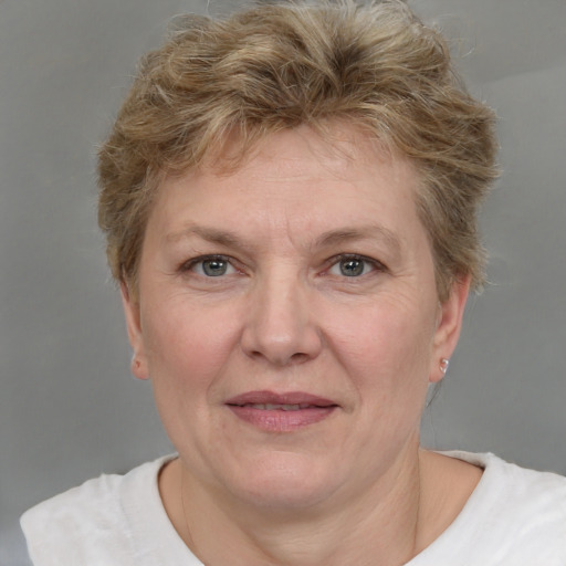 Joyful white adult female with short  brown hair and grey eyes