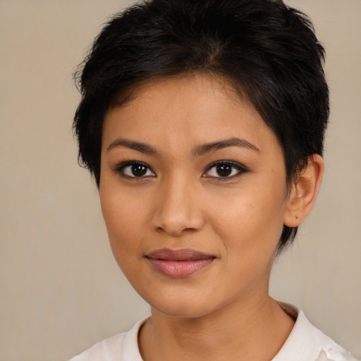 Joyful latino young-adult female with short  brown hair and brown eyes