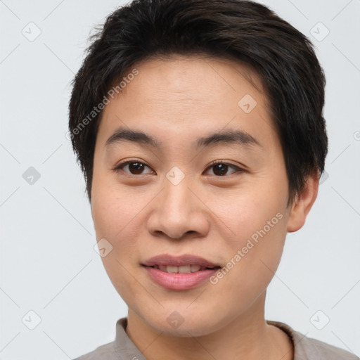 Joyful asian young-adult male with short  brown hair and brown eyes