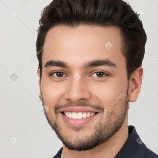 Joyful white young-adult male with short  brown hair and brown eyes