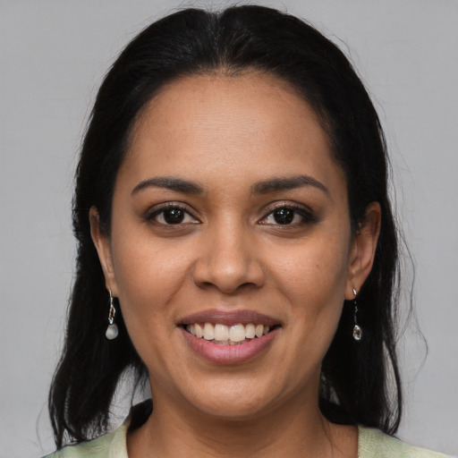 Joyful latino young-adult female with long  brown hair and brown eyes