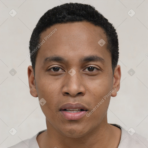 Joyful black young-adult male with short  black hair and brown eyes