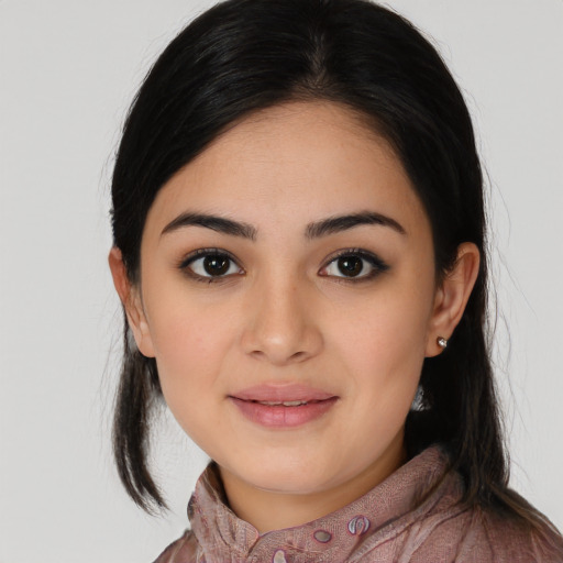 Joyful latino young-adult female with long  black hair and brown eyes