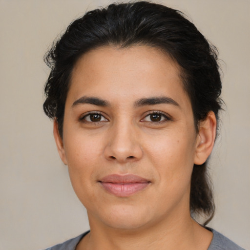 Joyful latino young-adult female with medium  brown hair and brown eyes