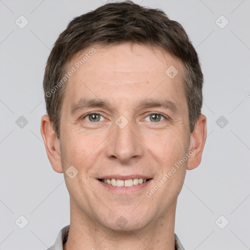 Joyful white adult male with short  brown hair and grey eyes