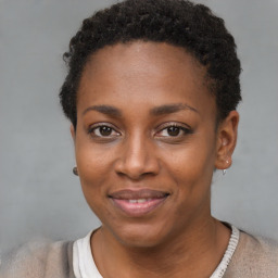 Joyful black young-adult female with short  brown hair and brown eyes