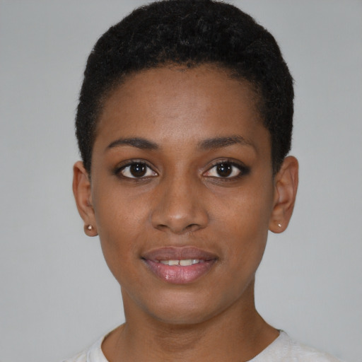 Joyful black young-adult female with short  black hair and brown eyes