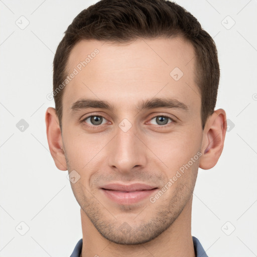 Joyful white young-adult male with short  brown hair and grey eyes