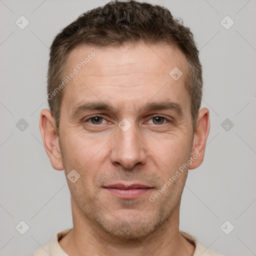 Joyful white adult male with short  brown hair and brown eyes