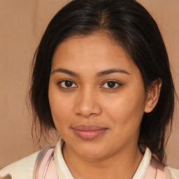 Joyful latino young-adult female with medium  brown hair and brown eyes