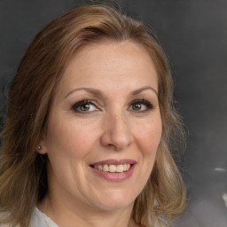 Joyful white adult female with long  brown hair and brown eyes