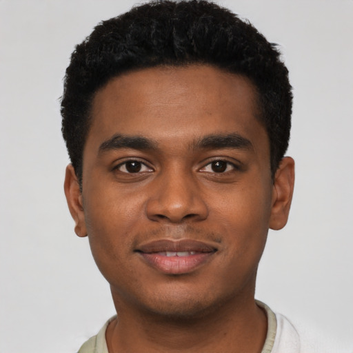 Joyful black young-adult male with short  black hair and brown eyes