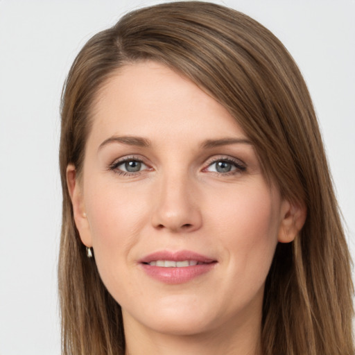 Joyful white young-adult female with long  brown hair and grey eyes