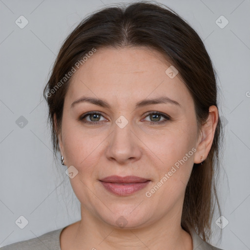 Joyful white adult female with medium  brown hair and brown eyes