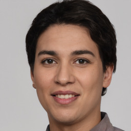 Joyful white young-adult male with short  black hair and brown eyes