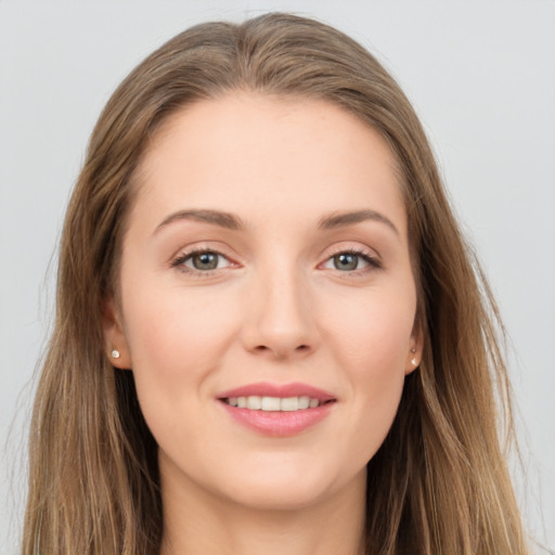 Joyful white young-adult female with long  brown hair and grey eyes