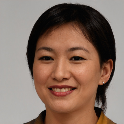 Joyful asian young-adult female with medium  brown hair and brown eyes