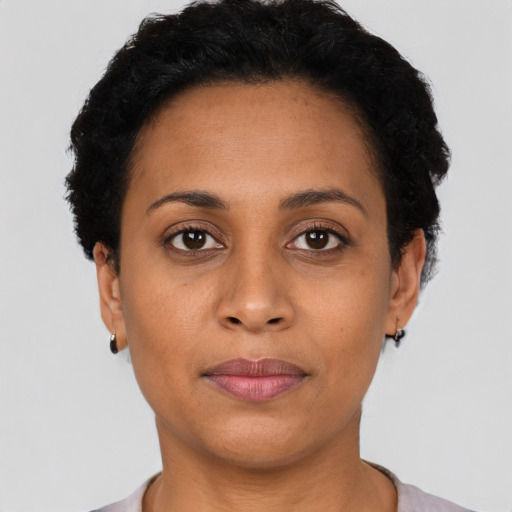 Joyful latino young-adult female with short  black hair and brown eyes