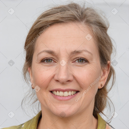 Joyful white adult female with medium  brown hair and grey eyes