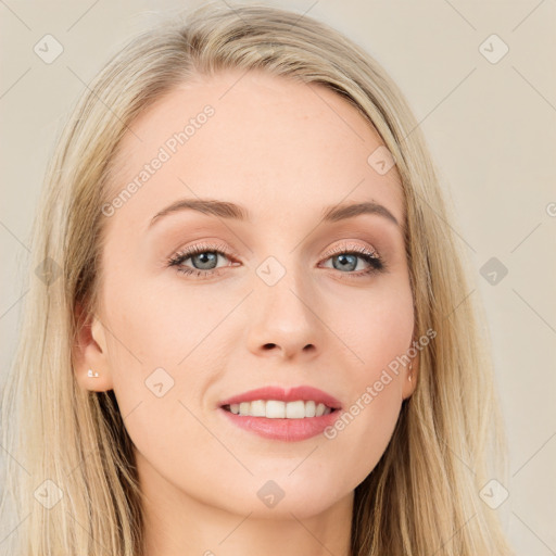 Joyful white young-adult female with long  brown hair and blue eyes