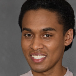 Joyful latino young-adult male with short  brown hair and brown eyes