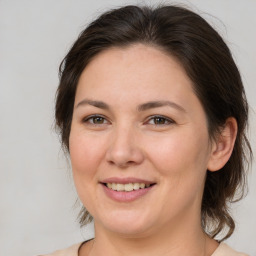 Joyful white adult female with medium  brown hair and brown eyes