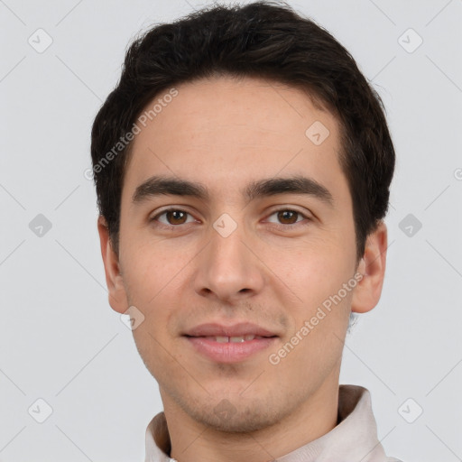 Joyful white young-adult male with short  black hair and brown eyes