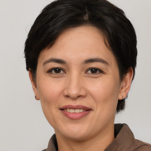 Joyful white adult female with medium  brown hair and brown eyes