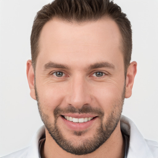 Joyful white young-adult male with short  brown hair and brown eyes