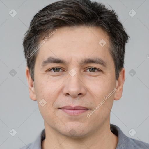 Joyful white adult male with short  brown hair and brown eyes