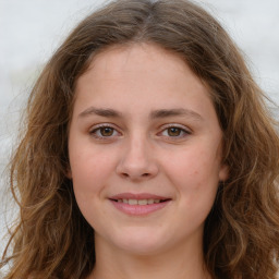 Joyful white young-adult female with long  brown hair and green eyes